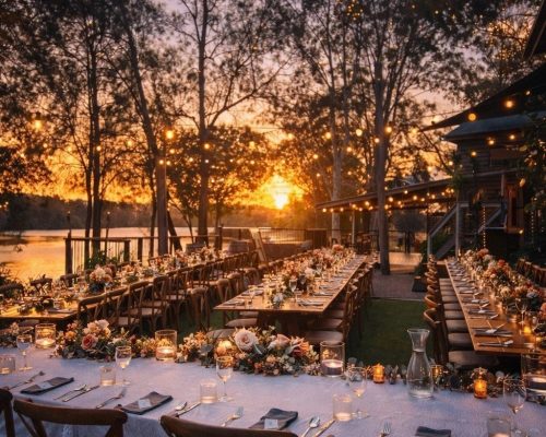 Long-table wedding reception at sunset on the river terrace at The Rocks Yandina